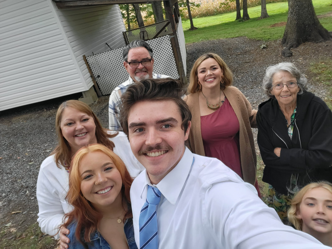 Seven people posing for a selfie.